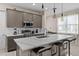 Well-equipped kitchen with stainless steel appliances, a central island, and bar stool seating, offering a functional cooking space at 772 Driving Range Ct, Kissimmee, FL 34747