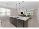 Modern kitchen with an island and pendant lights open to dining area and living room at 772 Driving Range Ct, Kissimmee, FL 34747