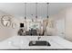 Kitchen with view of dining room and living room, featuring modern pendant lighting and island sink at 772 Driving Range Ct, Kissimmee, FL 34747