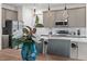 Kitchen with gray cabinets, stainless steel appliances and a view of the dining area at 772 Driving Range Ct, Kissimmee, FL 34747