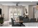 Living room with modern decor, ceiling fan, and large windows with sheer curtains at 772 Driving Range Ct, Kissimmee, FL 34747