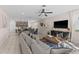Open-concept living area blends seamlessly with kitchen, featuring stylish decor and tile flooring at 772 Driving Range Ct, Kissimmee, FL 34747