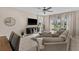 Bright living room featuring tile floors, modern furnishings, and large windows with natural light at 772 Driving Range Ct, Kissimmee, FL 34747