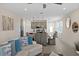 Inviting living space open to kitchen and dining area; features a large sofa and tile floors at 772 Driving Range Ct, Kissimmee, FL 34747