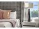 Beautifully decorated bedroom features a gray headboard, luxury bedding, and a modern bedside lamp at 772 Driving Range Ct, Kissimmee, FL 34747