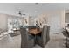 Open floor plan with dining area, living room, and staircase featuring neutral colors at 772 Driving Range Ct, Kissimmee, FL 34747