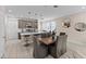 Open floor plan featuring modern kitchen, dining area and living room with tile floors at 772 Driving Range Ct, Kissimmee, FL 34747