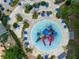 Aerial view of a modern waterpark with blue umbrellas, slides, and lounge chairs at 772 Driving Range Ct, Kissimmee, FL 34747