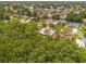 Aerial view captures this home surrounded by mature trees in a residential neighborhood at 778 Del Prado Dr, Kissimmee, FL 34758