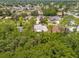 Aerial view showcases the home nestled among mature trees in a quiet neighborhood at 778 Del Prado Dr, Kissimmee, FL 34758