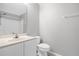 Neutral bathroom with a large mirror, simple vanity and standard toilet at 778 Del Prado Dr, Kissimmee, FL 34758