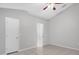 Neutral bedroom with tile flooring and a door leading to a bathroom at 778 Del Prado Dr, Kissimmee, FL 34758