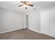 Neutral bedroom featuring a ceiling fan, closet, neutral carpeting and a door at 778 Del Prado Dr, Kissimmee, FL 34758