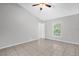 Bright bedroom featuring neutral paint, a ceiling fan, and large window for natural light at 778 Del Prado Dr, Kissimmee, FL 34758
