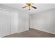 Neutral bedroom featuring a ceiling fan, door and large double door closet at 778 Del Prado Dr, Kissimmee, FL 34758