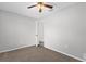 Neutral bedroom with neutral carpeting, a ceiling fan and door at 778 Del Prado Dr, Kissimmee, FL 34758