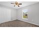 Neutral bedroom with neutral carpeting, a window, and a double door closet at 778 Del Prado Dr, Kissimmee, FL 34758