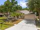 Lovely single-story home with a driveway, front lawn and mature trees at 778 Del Prado Dr, Kissimmee, FL 34758