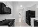 Well-lit kitchen featuring white cabinetry, black appliances and tile flooring at 778 Del Prado Dr, Kissimmee, FL 34758