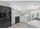 Bright kitchen with white countertops, tile flooring, and a modern black stainless steel refrigerator at 778 Del Prado Dr, Kissimmee, FL 34758
