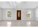 Bright living room featuring neutral paint, tile floors, and natural light from dual windows at 778 Del Prado Dr, Kissimmee, FL 34758