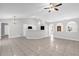 Bright living room with neutral paint, tile floors, and a view into the kitchen at 778 Del Prado Dr, Kissimmee, FL 34758