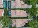Overhead capture presents a tile-roofed property featuring a private screened-in pool and manicured landscaping at 8333 Via Verona, Orlando, FL 32836