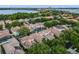 Picturesque aerial view of the neighborhood with mature trees and community lake views at 8333 Via Verona, Orlando, FL 32836