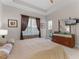 Relaxing bedroom with a plush bed, a modern dresser, and natural light streaming through the window at 8333 Via Verona, Orlando, FL 32836