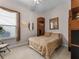 Cozy bedroom featuring a comfortable bed, window with blinds, and functional storage units for an organized space at 8333 Via Verona, Orlando, FL 32836