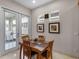 Cozy dining area with natural light, a wooden table set, and view to the backyard at 8333 Via Verona, Orlando, FL 32836