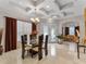Elegant dining room featuring a glass-top table, high ceilings, and an open view to the entry at 8333 Via Verona, Orlando, FL 32836