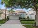 Charming single-story home featuring a brick driveway, two-car garage, and well-maintained landscaping at 8333 Via Verona, Orlando, FL 32836