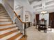 Spacious interior featuring staircase, dining room with glass table, and view to living area at 8333 Via Verona, Orlando, FL 32836