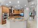 Open concept kitchen with granite countertops, stainless steel appliances, and ample cabinet space at 8333 Via Verona, Orlando, FL 32836