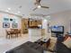 Inviting living room featuring sleek tile flooring, an open kitchen concept, and ample natural light from nearby windows at 8333 Via Verona, Orlando, FL 32836
