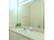 Clean bathroom featuring a vanity with a sink, a large mirror, and a neutral color scheme, with a toilet barely visible at 8502 Crystal Cove Loop, Kissimmee, FL 34747