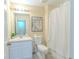 Bright bathroom with a white vanity, toilet, and shower-tub combo at 8502 Crystal Cove Loop, Kissimmee, FL 34747