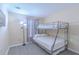 Bedroom with a bunk bed, wood-style flooring, neutral walls, and a modern lamp at 8502 Crystal Cove Loop, Kissimmee, FL 34747