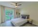 Cozy bedroom featuring a queen-size bed, balcony access, and natural light at 8502 Crystal Cove Loop, Kissimmee, FL 34747