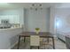 Open-concept dining room and kitchen featuring stainless appliances, a table with chairs, and modern light fixture at 8502 Crystal Cove Loop, Kissimmee, FL 34747