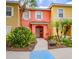 Charming townhome with colorful exterior, manicured landscaping, and a welcoming entrance at 8502 Crystal Cove Loop, Kissimmee, FL 34747