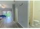 Hallway with a full bathroom, modern flooring, and direct access to the living room, offering convenience and style at 8502 Crystal Cove Loop, Kissimmee, FL 34747