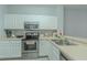 Well-lit kitchen featuring stainless steel appliances, sleek countertops, and ample cabinet space for storage at 8502 Crystal Cove Loop, Kissimmee, FL 34747