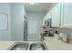 Bright kitchen with stainless steel appliances, including a fridge, microwave and modern countertops, plus a stainless steel sink at 8502 Crystal Cove Loop, Kissimmee, FL 34747