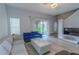Cozy living area with comfortable seating, including a marble coffee table, and access to the balcony, creating a relaxing space at 8502 Crystal Cove Loop, Kissimmee, FL 34747