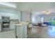Open-concept living space featuring stainless appliances, modern finishes, and abundant natural light from sliding glass doors at 8502 Crystal Cove Loop, Kissimmee, FL 34747