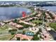 Aerial view of waterfront homes with well-manicured lawns and tree-lined streets in a desirable community at 8515 Saint Marino Blvd, Orlando, FL 32836