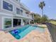 Beautiful backyard pool with a lounge chair and grill, overlooking the lake at 8515 Saint Marino Blvd, Orlando, FL 32836