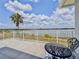 Balcony with black metal table and chairs that overlooks the lake and surrounding greenery at 8515 Saint Marino Blvd, Orlando, FL 32836